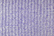 Jersey textile background , purple white melange knitted wool fabric. Woolen knitwear, sweater, pullover surface texture, textile structure, cloth surface, weaving of knitwear material