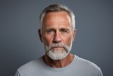 Fototapeta  - Portrait of a senior man with gray hair and beard. Studio shot.