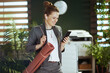 © Alliance - smiling business woman at work using smartphone applications