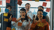 Happy business team celebrate successful project at glass wall. Group of professional diverse business people shaking hand, high five, thumb up at business meeting. Creative business. Manipulator.