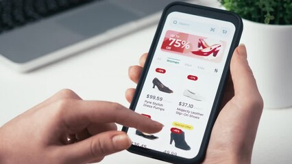 Shopping online for Christmas using smartphone retail app. Holiday sale with great discounts and special offers. Scrolling through a catalog of shoes. Fictional interface.