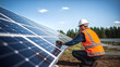 © Jarumas - Picture of contrition guy installing solar panels in a solar farm, energy saving concept, climate change concept.