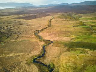 Wall Mural - Irelands West on Achill Island. Drone shot of a river.