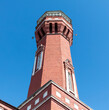 Red brick tower against a blue sky