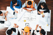 Top view banner of diverse group of civil engineer and client working together on architectural project, reviewing construction plan and building blueprint at meeting table. Prudent