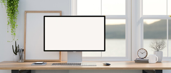 Wall Mural - a pc computer mockup with accessories on a wooden desk against the window in a modern white room.