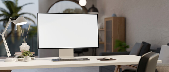Wall Mural - a white-screen pc computer mockup, a table lamp, and accessories on a white desk in a modern room.