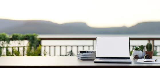 Poster - front view of a workspace on a balcony with a white-screen laptop computer mockup on a table.