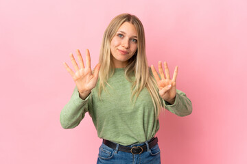 Wall Mural - Young blonde woman isolated on pink background counting nine with fingers