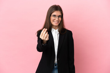 Wall Mural - Young Business caucasian woman isolated on pink background making money gesture