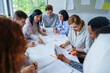 © Westend61 - Multi-ethnic students studying together at desk in training class