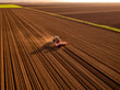 © Westend61 - Serbia, Vojvodina Province, Aerial view of tractor sowing seeds in plowed corn field