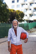 © Halfpoint - Senior man playing basketball outdoors on basketball court in city. Older, vital man has active lifestyle, doing sport every day.