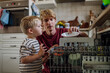 © Halfpoint - Little boy helping father to load dishwasher after breakfast. Cleaning the kitchen before leaving to work and daycare. Family morning routine.