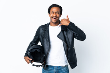 Canvas Print - African American man with braids holding a motorcycle helmet isolated on white background making phone gesture. Call me back sign