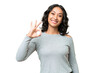© luismolinero - Young Argentinian woman over isolated background showing ok sign with fingers