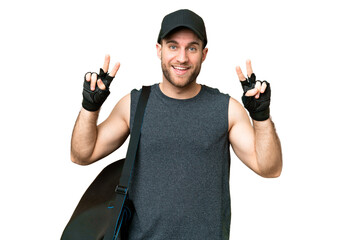 Wall Mural - Young sport man with sport bag over isolated chroma key background showing victory sign with both hands