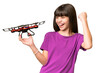 © luismolinero - Little caucasian girl holding a drone over isolated background celebrating a victory