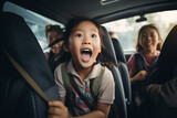 Fototapeta Łazienka - a little girl is sitting in the back seat of a car