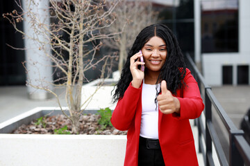 Wall Mural - african businesswoman calling on phone with hand gesture