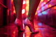 Sensual female legs in sexy high heels in a provocative red light district nightclub.