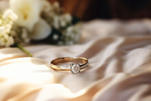 Beautiful Golden Engagement Ring And Bouquet With White Roses