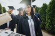 © qunica.com - Graduates in caps and gowns celebrate milestones, creating lasting memories. Friends, faculty, and students come together in a park, showcasing successful teamwork and achievement.