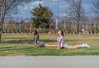 Wall Mural - Fit, alluring sportsgirls exercising in the park, on a sunny day