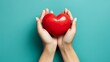Hands holding red heart on isolate blue background. Health care love organ donation mindfulness wellbeing praying family insurance CSR and mental concept. World heart day and World health day