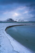 Classic scenic view in Lofoten with winter mood and snowcapped mountains and snow covered beach