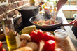 © Marko Geber - Close up woman cooking healthy pasta meal in home kitchen