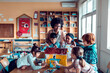 © Marko Geber - Diverse young children working on school project with teacher in classroom