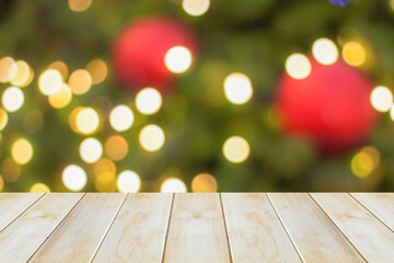Poster - Empty wood table top with blur Christmas tree with bokeh light background