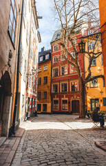  morning beautiful light on narrow street in old town with orange walls in stockholm