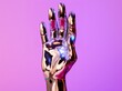 © IgnacioJulian - a hand that is shaped as a metallic hand on the purple background