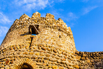 Poster - travel to Georgia - bottom view of tower of fortification wall of Signagi town in Kakheti region in Georgia in autumn sunset