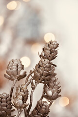 Wall Mural - Close up decorative pinecones with christmas lights in the background.