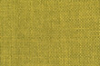 A green woven fabric texture. The image is a full frame of the fabric with a slight variation in the color and texture.
