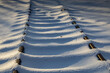 a romantic winter image of sunken tracks of a little-used track