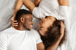 © Prostock-studio - Black Lovers Couple Lying Hugging In Bed Indoor, Top View