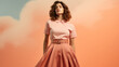 Beautiful European woman with dark hair in an original fashionable blouse and skirt in Peach Fuzz color. Fashion and trends