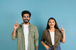 © Prostock-studio - Inspired young indian man and woman raising fingers up