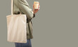 Modern trendy eco tote bag on shoulder. Shopper, green banner background