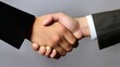 © OKAN - Business handshake on grey background.