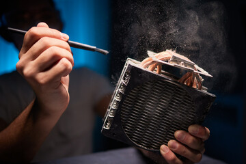 Cleaning a processor fan with a brush