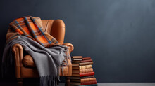 A cozy leather armchair draped with a plaid blanket next to a stack of books