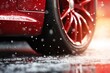 a red car wheel close-up on the background of a winter snow-covered road with ice, the concept of traffic safety on a slippery road