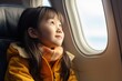 © Маргарита Вайс - adorable little asian girl looks out the airplane window