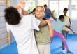© JackF - Girls and boys learns to do power grip with trainer during a self-defense lesson in the gym