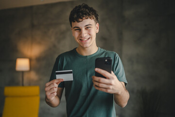 teenager young man at home use credit card shopping online e-banking